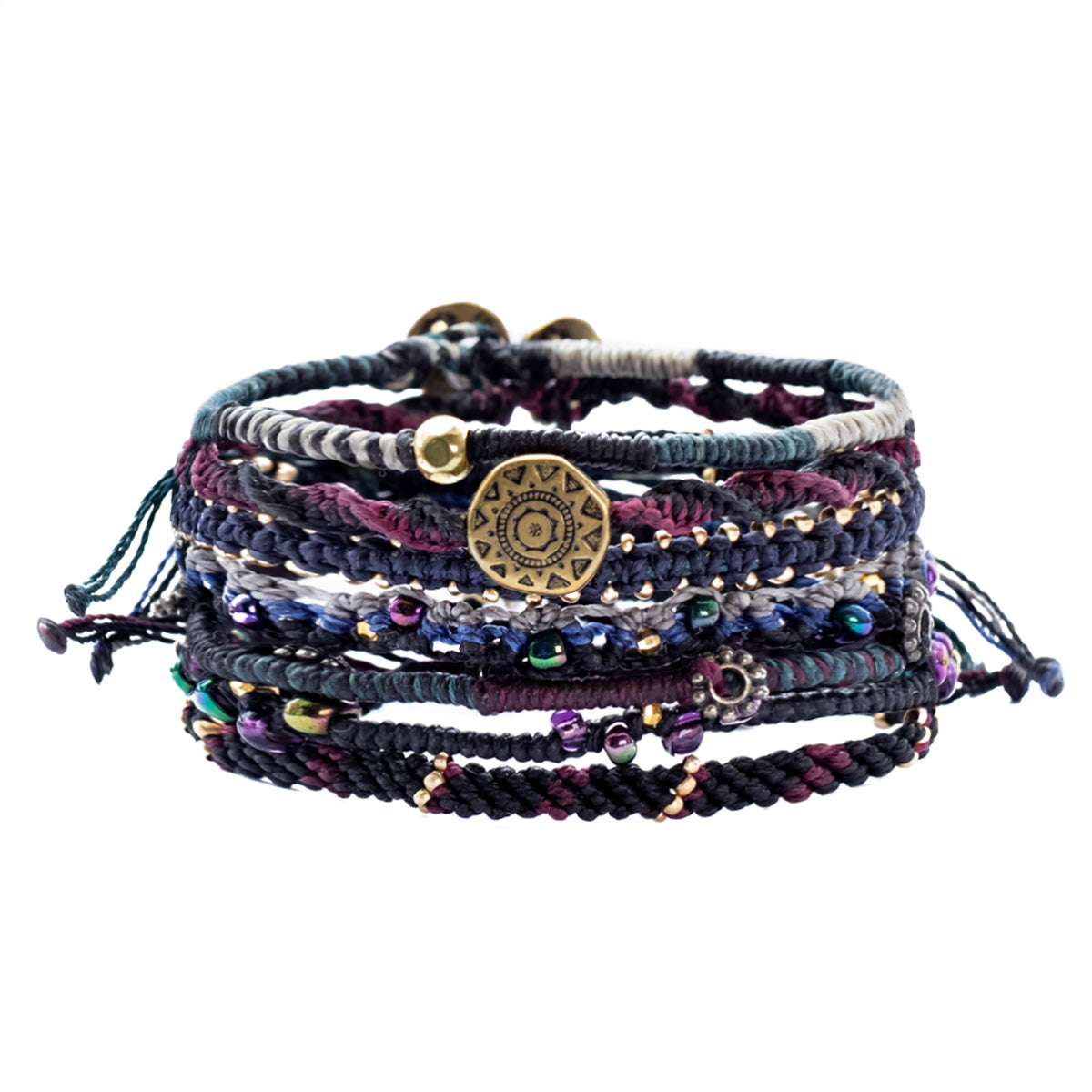 Colorful, intricately braided bracelets stacked together, with beads and a circular pendant.