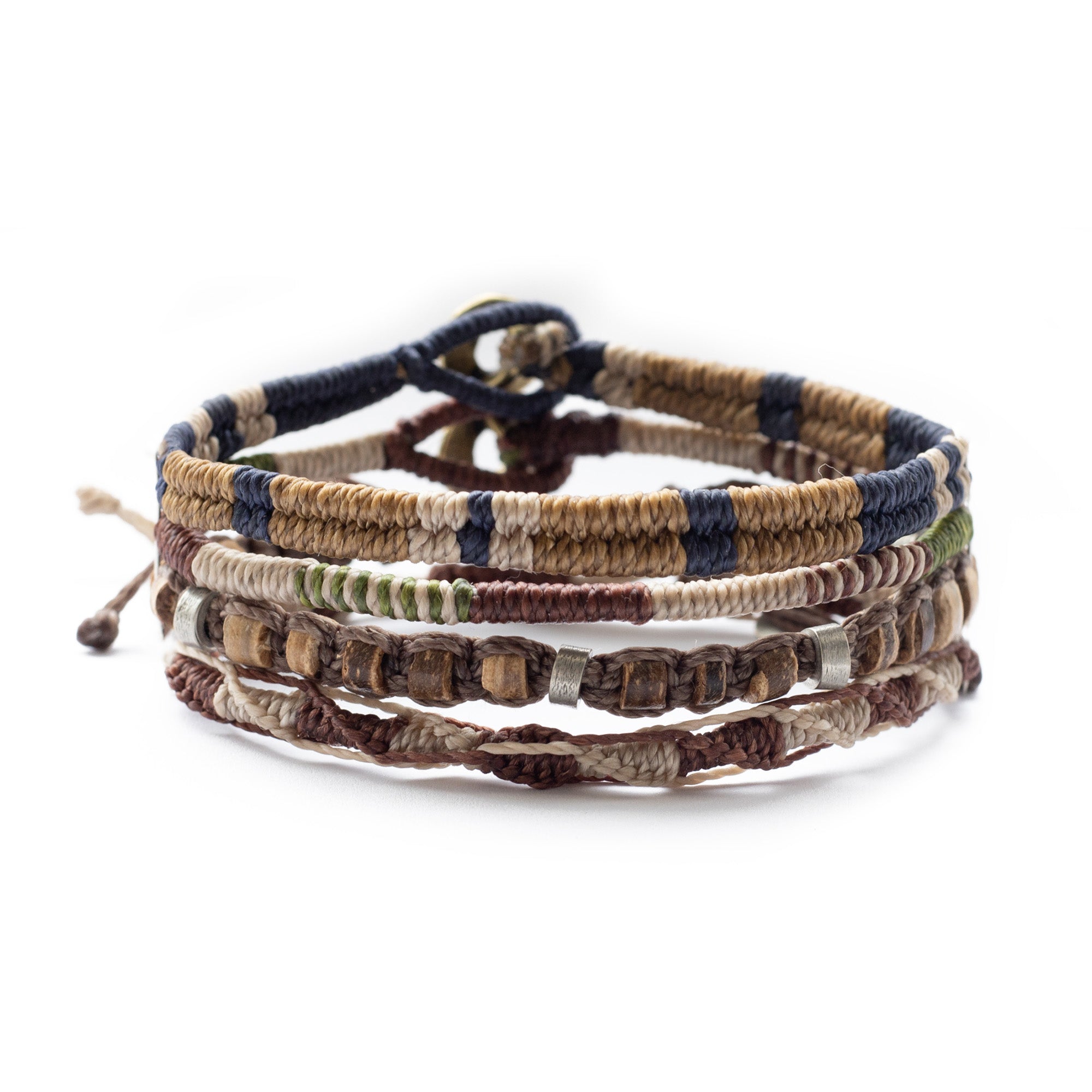 Stack of braided and beaded bracelets in earth tones.